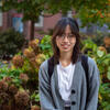 Masters student Linh Vo stands smiling on campus