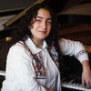 Negar Ghasemi posing with her piano